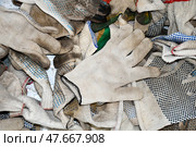 A pile of dirty work gloves. Хлопчатобумажные рабочие перчатки после использования свалены в кучу. Работа завершена. Стоковое фото, фотограф Ольга Солопова / Фотобанк Лори