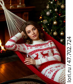 Beautiful girl with a glass of wine relaxing in a hammock. Стоковое AI-изображение, AI-художник Сергей Елизарьев / Фотобанк Лори