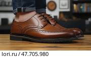 Stylish Brown Leather Brogue Shoes on Wooden Surface. Стоковое AI-изображение, AI-художник Данила Большаков / Фотобанк Лори
