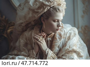 Portrait of a young woman in a luxurious historical outfit, decorated with gold patterns and jewelry. She is dressed in an outfit inspired by the Baroque or Renaissance era, with an exquisite headdress and massive jewelry. Her pose is thoughtful, her gaze is lowered. The atmosphere of the photo is elegant, refined, with a touch of old-fashioned aristocracy. Perfect for themes related to fashion history, art, royal themes, costume shoots and the aesthetics of past eras. Стоковое AI-изображение, AI-художник Анна Кривицкая / Фотобанк Лори