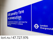 London Overground Blue Sign Displaying Fare and Concession Information for Passengers. Стоковое фото, фотограф Zydrius Tartenis / Фотобанк Лори
