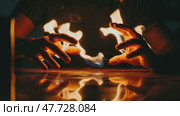 Hands manipulating flames reflected on a surface. Стоковое AI-видео, аниматор KATERINA AI / Фотобанк Лори