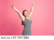 Happy pize size model in striped dress, fat woman on purple background. Стоковое фото, фотограф Станислав Тарко / Фотобанк Лори