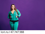 Plus size model in tracksuit, fat woman on purple background. Стоковое фото, фотограф Станислав Тарко / Фотобанк Лори