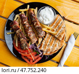 Shishqebap with French fries, tomatoes and pita bread. Albanian cuisine. Стоковое фото, фотограф Яков Филимонов / Фотобанк Лори