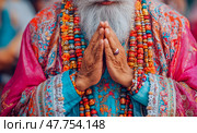 Devotion Manifest: Close-up of Praying Hands with Colorful Beads and Ornate Clothing, Spirituality and Tradition. Стоковое AI-изображение, AI-художник Данила Большаков / Фотобанк Лори