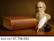 Собрание сочинений. Книга Л.Н. Толстого с пером и чернильницей на фоне бюста. Стоковое AI-изображение, AI-художник Башкирова Анна / Фотобанк Лори