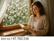 Чтение у окна. Женщина сидит у окна с книгой, весенний сад за стеклом. Стоковое AI-изображение, AI-художник Башкирова Анна / Фотобанк Лори