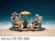 Miniature people figurine senior couple in sunhat and sunglasses relaxing with cocktail lying on sunbed at socean beach, created with Generative AI. Стоковое AI-изображение, AI-художник Данила Большаков / Фотобанк Лори