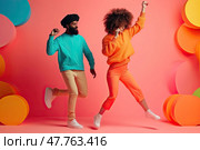 Burst of colors and exuberance fills the scene as African-American couple showcases their infectious dance moves, radiating happiness against vibrant pink background with abstract multicolored circles. Стоковое AI-изображение, AI-художник Данила Большаков / Фотобанк Лори