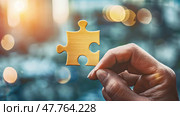 A persons hand carefully holds a single puzzle piece, signifying the act of solving a puzzle. Стоковое AI-изображение, AI-художник Данила Большаков / Фотобанк Лори