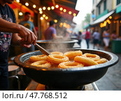 Street Vendor Frying Churros in Hot Oil at a Vibrant Market, Sizzling Golden Dough in a Lively Atmosphere. Стоковое AI-изображение, AI-художник Sergey Grishin / Фотобанк Лори