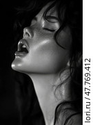A woman with curly hair and freckles displays a powerful emotional expression under creative lighting, highlighting her features beautifully. Стоковое AI-изображение, AI-художник Данила Большаков / Фотобанк Лори