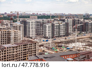 Construction Activities Underway at a Large Urban Development Site in a Bustling City. Стоковое фото, фотограф Aleksandr Golubev / Фотобанк Лори