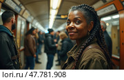 A Woman With Braided Hair Smiles and Gazes at the Camera While Standing Among Commuters in a Bustling Subway Station. Стоковое AI-изображение, AI-художник Sergey Grishin / Фотобанк Лори