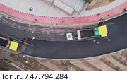 A drone over a section of the city's asphalt road during repairs. Sunny summer day. Стоковое видео, видеограф Aleksey Kidisyuk / Фотобанк Лори