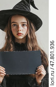 Young witch holding blank sign in costume, expressive face changes captured. Стоковое AI-видео, аниматор Sabyna75 / Фотобанк Лори