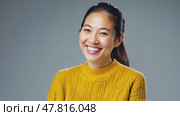 Beautiful, attractive, Asian woman in yellow sweater and shining smile confidently looking at camera, 4k, active lifestyle. Business concept, thinking about something, passionate about hobby. Стоковое AI-видео, аниматор ALLA YURTAYEVA / Фотобанк Лори
