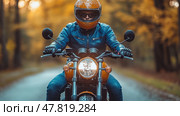 A motorcyclist in a leather jacket rides along a scenic forest road, surrounded by vibrant autumn leaves during sunset. Стоковое AI-изображение, AI-художник Данила Большаков / Фотобанк Лори