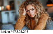 The woman rests her head on her hand, appearing deep in thought or concern while surrounded by a warm, inviting atmosphere. Стоковое AI-изображение, AI-художник Данила Большаков / Фотобанк Лори