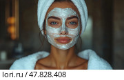 A young woman applies a facial mask, looking relaxed and refreshed in a cozy bathroom while wearing a towel around her hair during the day. Стоковое AI-изображение, AI-художник Данила Большаков / Фотобанк Лори