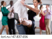 During rehearsal, male dancer holds partners leg, performs support. Стоковое фото, фотограф Яков Филимонов / Фотобанк Лори