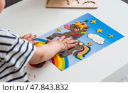 A little boy is playing with plasticine. Fine motor skills-developing games for children. The kid makes a horse. Useful games for child development. Стоковое фото, фотограф Photojuli / Фотобанк Лори