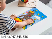 A little boy is playing with plasticine. Fine motor skills-developing games for children. The kid makes a horse. Useful games for child development. Стоковое фото, фотограф Photojuli / Фотобанк Лори