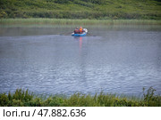 ishermen floats on the lake in the boat and fishing. Morning with fog over water. (2023 год). Редакционное фото, фотограф Сергей Пристяжнюк (Serg Zastavkin) / Фотобанк Лори