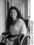 A woman sitting in a wheelchair smiling directly at the camera. Стоковое AI-изображение, AI-художник Данила Большаков / Фотобанк Лори