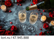 Champagne, candles and red roses on a gray concrete background. Top view. Valentines drinks for for a pair of lovers. Bartender pours sparkling wine or prosecco into glasses. Romance. Wedding Day. Стоковое AI-изображение, AI-художник Марина Демидюк / Фотобанк Лори