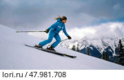 Skier descends from mountain in full gear. An athlete conquers the descent from a mountain peak on skis. Стоковое AI-изображение, AI-художник Антон Слабоспицкий / Фотобанк Лори