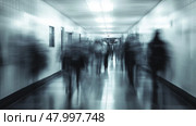 A somewhat blurry hospital corridor filled with numerous people walking about on their various errands and duties. Стоковое AI-изображение, AI-художник Anastasy Yarmolovich / Фотобанк Лори