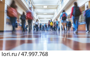 A somewhat blurry hospital corridor filled with numerous people walking about on their various errands and duties. Стоковое AI-изображение, AI-художник Anastasy Yarmolovich / Фотобанк Лори
