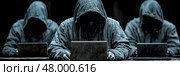 Three hooded individuals focus intently on their laptops in a dark setting, suggesting a clandestine activity or operation in progress. Стоковое AI-изображение, AI-художник Данила Большаков / Фотобанк Лори