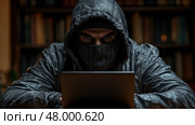 A hooded figure stares intently at a laptop in a dark setting filled with books, creating an atmosphere of secrecy and intrigue. Стоковое AI-изображение, AI-художник Данила Большаков / Фотобанк Лори