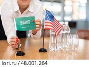 National flags of Saudi Arabia and United States on negotiating table. Стоковое фото, фотограф Яков Филимонов / Фотобанк Лори