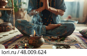 A person engages in meditation surrounded by aromatic smoke and calming elements in a peaceful indoor setting. Стоковое AI-изображение, AI-художник Данила Большаков / Фотобанк Лори