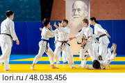 Moscow, Russia, April 24, 2025: Children practice martial arts with a coach in the gym, sambo, judo, aikido. Редакционное фото, фотограф Igor Skripachev / Фотобанк Лори