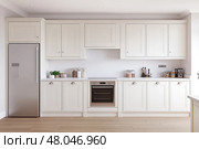 Modern trendy kitchen design with white cabinets. Subway tile backsplash, marble countertop. No brands or labels. Neutral contemporary design. Simply furniture with utensils, crockery, refrigerator. Стоковое AI-изображение, AI-художник Марина Демидюк / Фотобанк Лори