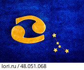Top view golden zodiac sign Cancer on blue velvet background. Стоковое фото, фотограф Алена Аксенова / Фотобанк Лори