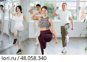 Smiling girl enjoying vigorous dance at group class. Стоковое фото, фотограф Яков Филимонов / Фотобанк Лори