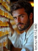 A laboratory technician with a beard closely inspects samples while surrounded by various vials on shelves at a scientific research facility. Стоковое AI-изображение, AI-художник Данила Большаков / Фотобанк Лори