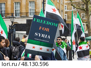 Freedom for Syria activists holding signs and flags during protest rally. London, UK, 16 March 2024. Редакционное фото, фотограф Zydrius Tartenis / Фотобанк Лори