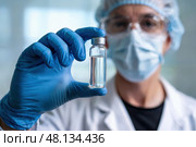 Male virologist holds a bottle of antiviral medication in his hand. Стоковое AI-изображение, AI-художник Дмитрий Киселёв / Фотобанк Лори