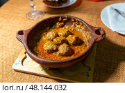 Flavorful kefta tagine cooked in rich tomato sauce, lamb meatballs, traditional moroccan delight. Стоковое фото, фотограф Евгений Ткачёв / Фотобанк Лори