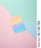 Two gradient-colored cards lie elegantly on a gently divided pastel backdrop, capturing the essence of tranquility and modern design in soft afternoon light Generative AI. Стоковое AI-изображение, AI-художник Юлия Петровская / Фотобанк Лори