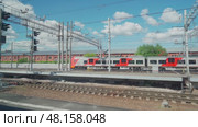 Saint-Petersburg, Russia - Jun 22 2022, 4k, view from the window of a moving train on the rails and standing trains, St. Petersburg, Russia. Редакционное видео, видеограф Сергей Богомяко / Фотобанк Лори