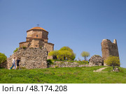 Tourists visit the Jvari Monastery on a sunny day. Mtskheta, Georgia (2019 год). Стоковое фото, фотограф EugeneSergeev / Фотобанк Лори