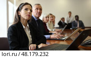 International group of business people listening to presentation at tables in conference room. Стоковое видео, видеограф Яков Филимонов / Фотобанк Лори